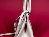 a white purse that is on a red surface