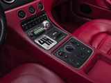 the interior of a red sports car with a radio and steering controls