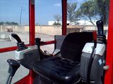 a red bus with a black seat and a steering wheel