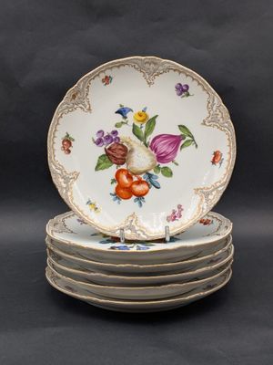 four plates are stacked on top of each other with flowers on them