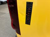 a sticker on the back of a yellow car