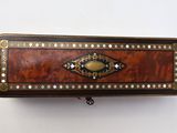 an image of a wooden box with a metal handle on a white wall