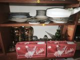 many plates and bowls on a shelf in the kitchen
