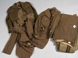 two pieces of military clothing sitting on top of a white surface