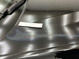 a sticker on the hood of a silver car