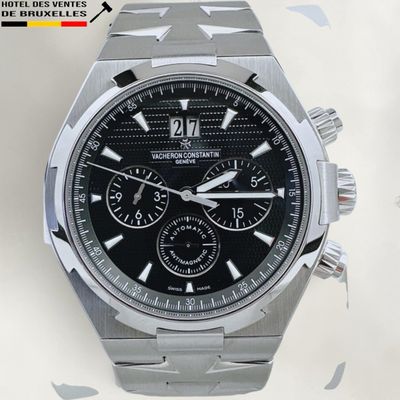 a close up of a watch with a black face