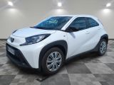 a white toyota c - hr parked on a checkered floor