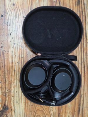 a pair of headphones in a case on a wooden table