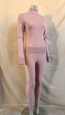 the mannequin is wearing a pink sweater and leggings