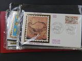 two envelopes with stamps on them sitting on a table