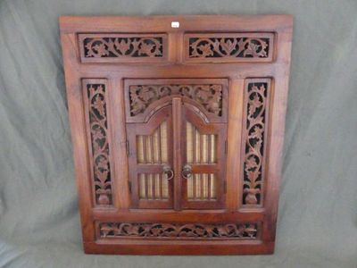 an old wooden cabinet with two doors and carvings on it