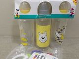 the baby bottle is in the packaging with a pacifier next to it