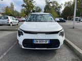 the front of a white car parked in a parking lot