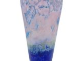 a blue and pink vase sitting on a white surface