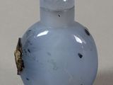 a picture of a blue glass snuff bottle on a table