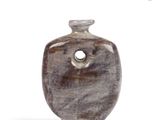 a small vase with a hole in the middle of it