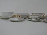 several cups and saucers are lined up on a table