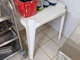 several pots and pans are stacked on a table in a kitchen