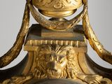 a gold clock that is sitting on a table