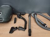 a vacuum that is sitting on a table next to other items