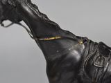 a statue of a horse with a saddle on it ' s back