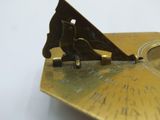 a gold plate with a bird on it on a table