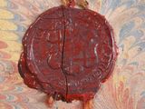 a wax seal on a piece of paper on a table