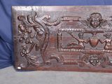 an antique carved wood panel with a picture of a man and a woman