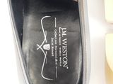 the bottom of a pair of black shoes with a white logo on it