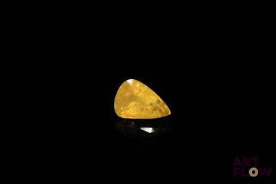 a close up of a yellow diamond on a black background