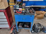 a blue workbench with tools on it in a garage
