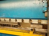 an image of a machine that is working on a piece of metal