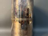 a silver vase that is sitting on a table
