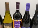 several bottles of wine are lined up on a table