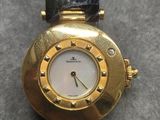 a close up of a watch on a table on a table