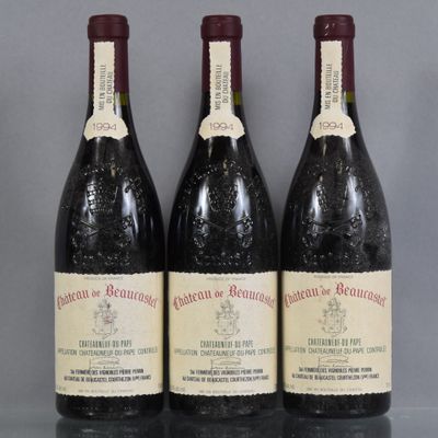 three bottles of wine are lined up on a table