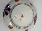 a white plate with a blue and red design on it