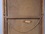 an old wooden box with a rope hanging from it ' s side