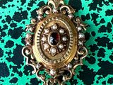 a close up of a broochle on a green surface