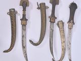 four different types of knives are displayed on a white surface