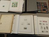 a lot of books on a table with stamps on them