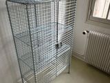 a cage that is sitting in the corner of a room