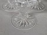 three wine glasses sitting on a table with a white table cloth