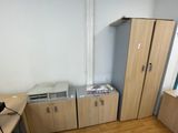 a room with a desk, cabinets, and a printer