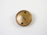 a close up of a metal button on a white surface