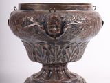 a silver vase with a bird on it on a white background