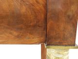 a close up view of a wooden table with a metal leg