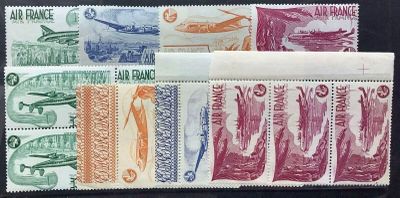 several different colored stamps on a black surface with a plane in the background