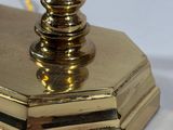 gold plated brass table lamp with a glass shade on top of it