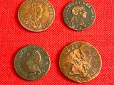 three different types of roman coins on a red cloth